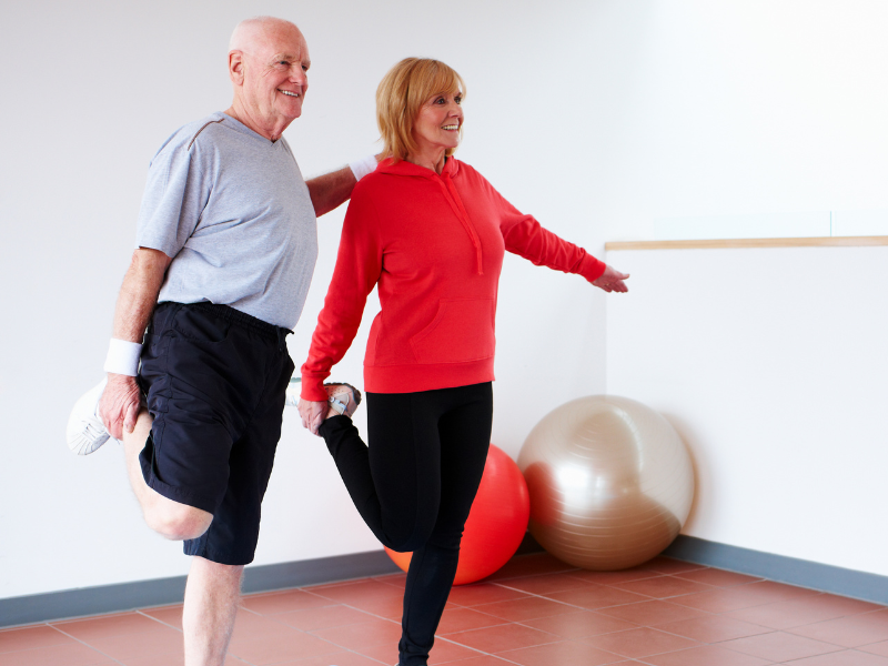A couple doing balancing exercises